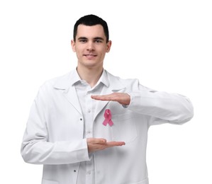 Portrait of smiling mammologist protecting pink ribbon on white background. Breast cancer awareness