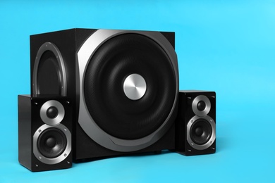 Modern powerful audio speaker system on light blue background