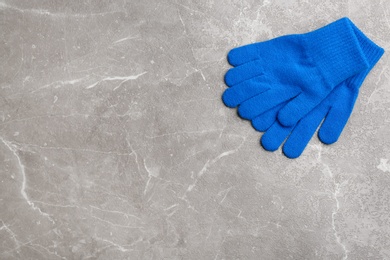 Stylish gloves on light grey marble table, flat lay. Space for text