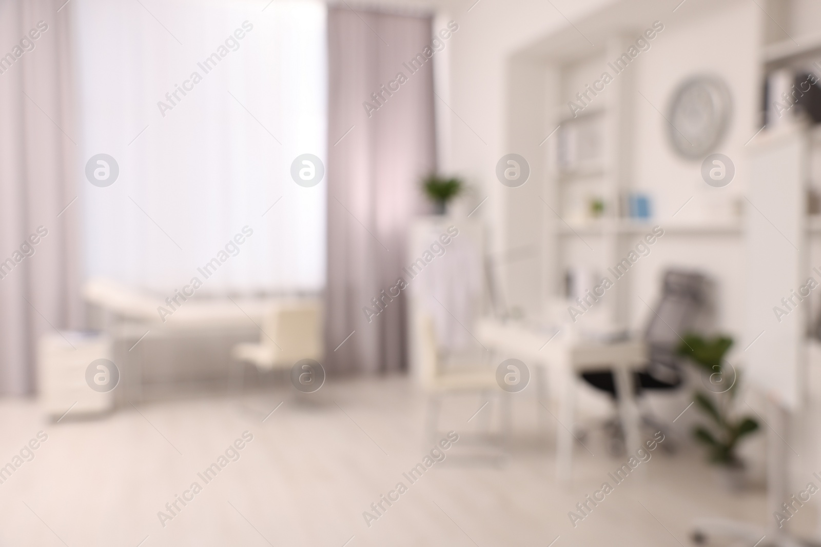 Photo of Blurred view of medical office interior with doctor's workplace