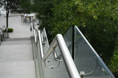 Photo of Outdoor staircase with metal handrails in park, closeup