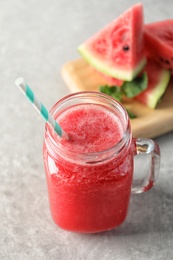 Photo of Tasty summer watermelon drink in mason jar on table, closeup