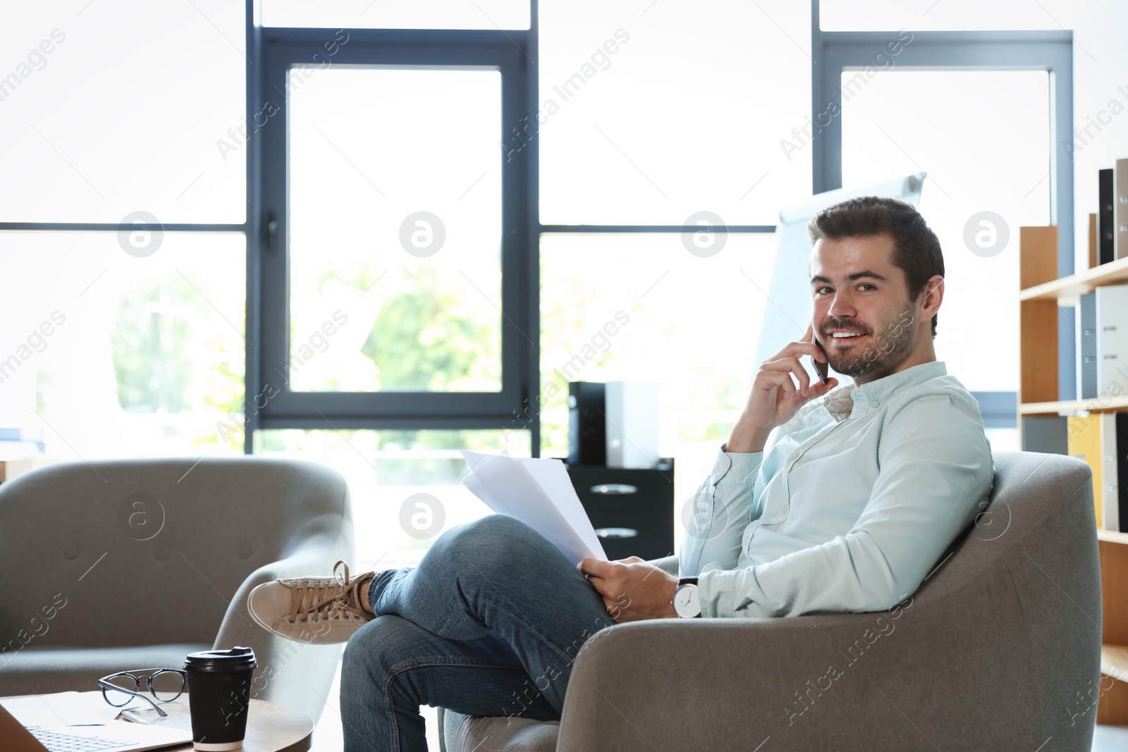 Photo of Male business trainer working with documents in office