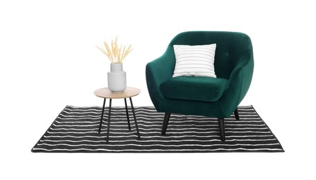 Stylish comfortable armchair, coffee table with decor and striped rug isolated on white