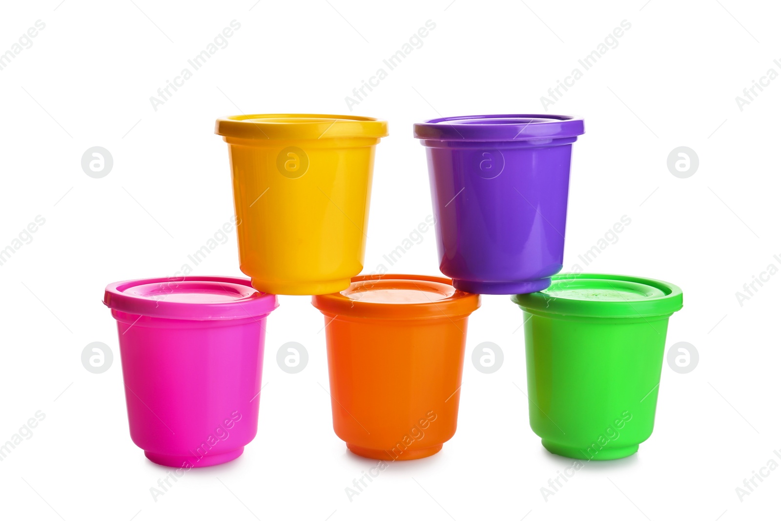 Photo of Colorful containers with play dough on white background