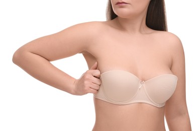Photo of Mammology. Woman in bra doing breast self-examination on white background, closeup