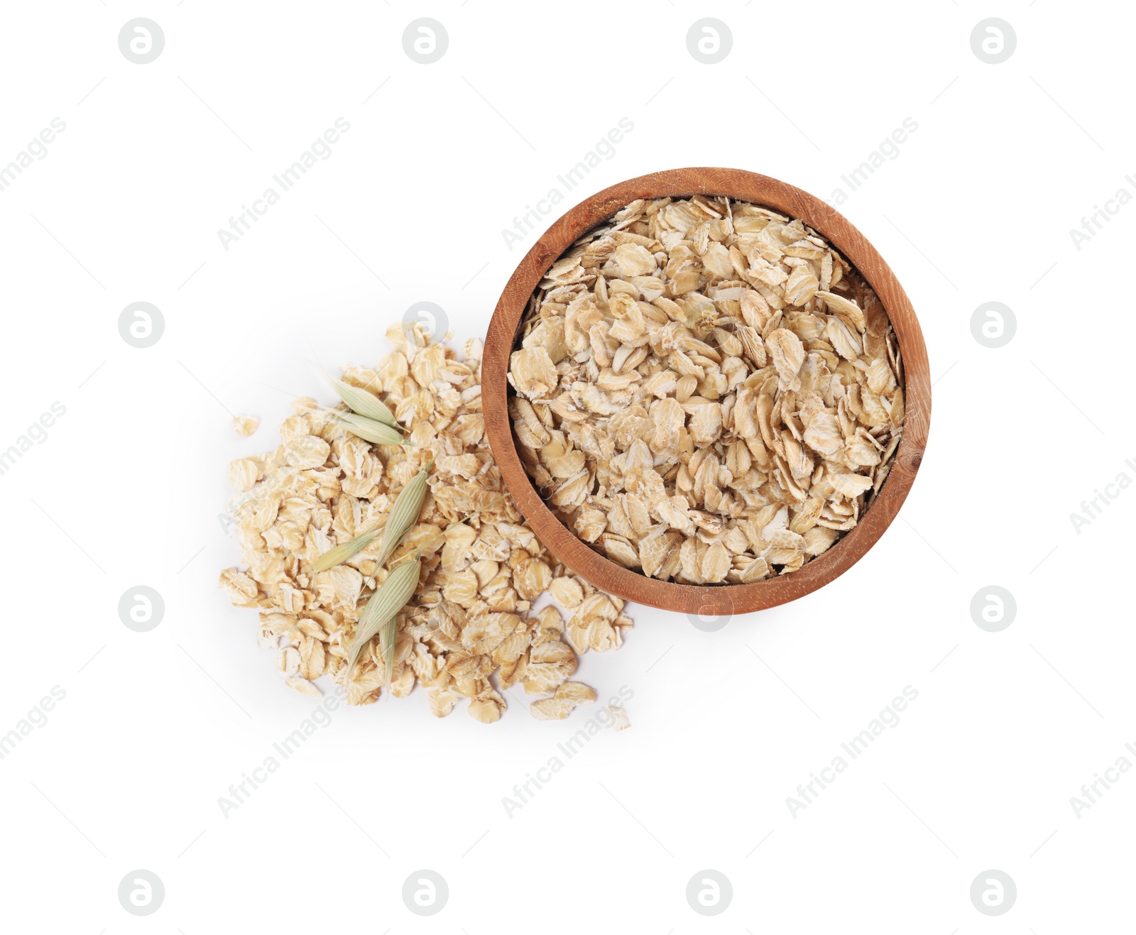 Photo of Wooden bowl with oatmeal and florets isolated on white, top view