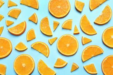 Flat lay composition with orange slices on color background