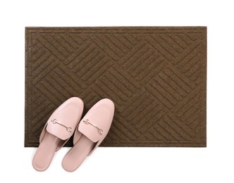 New clean door mat with shoes on white background, top view