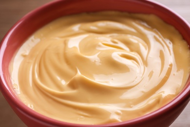 Photo of Tasty cheese fondue in ceramic pot, closeup view