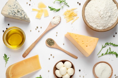 Photo of Flat lay composition with fresh ingredients for pizza on white background