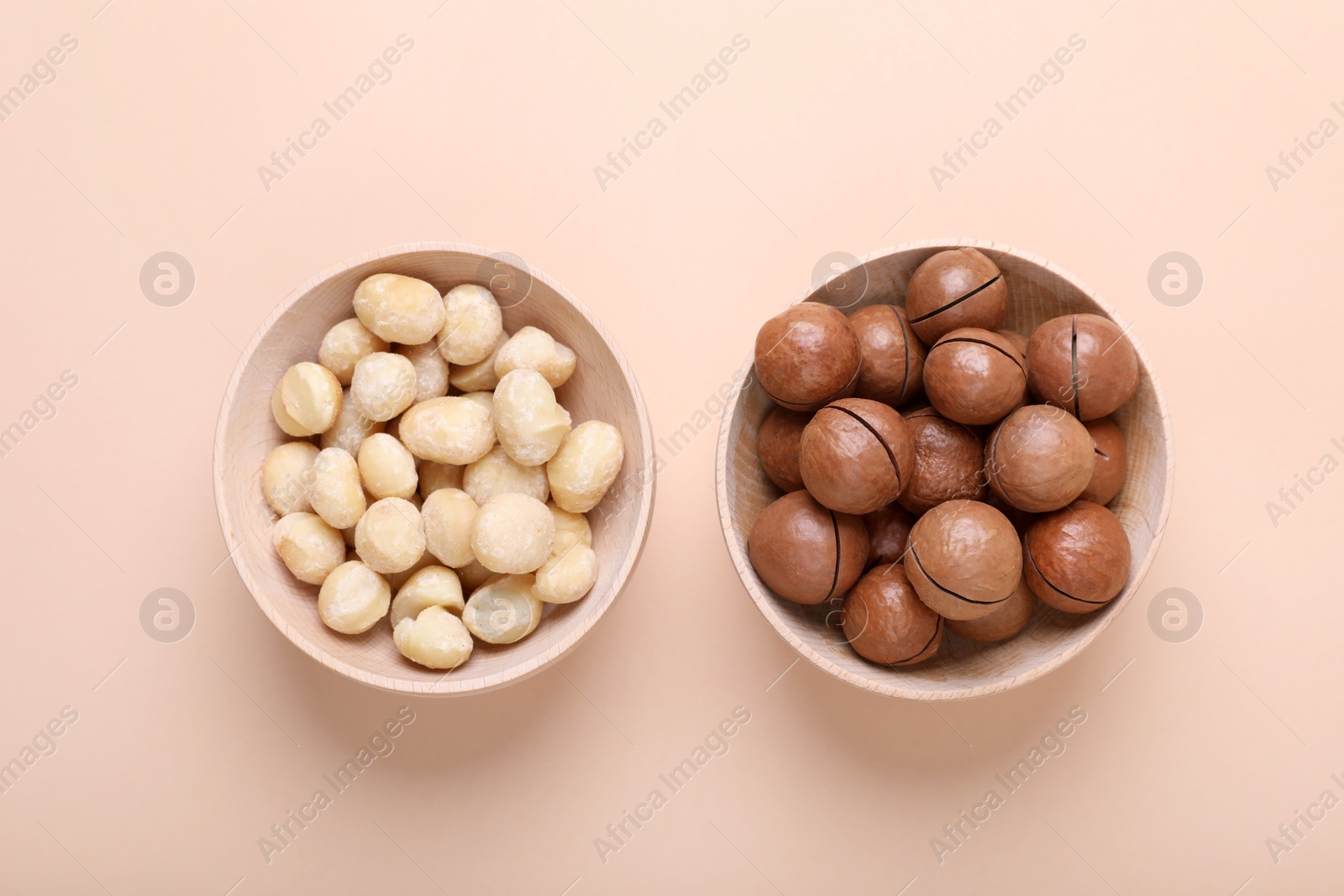 Photo of Delicious organic Macadamia nuts on beige background, flat lay