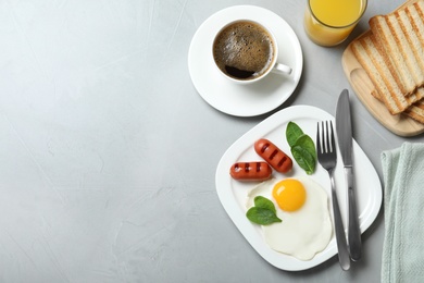 Photo of Delicious breakfast with fried egg served on table, flat lay. Space for text