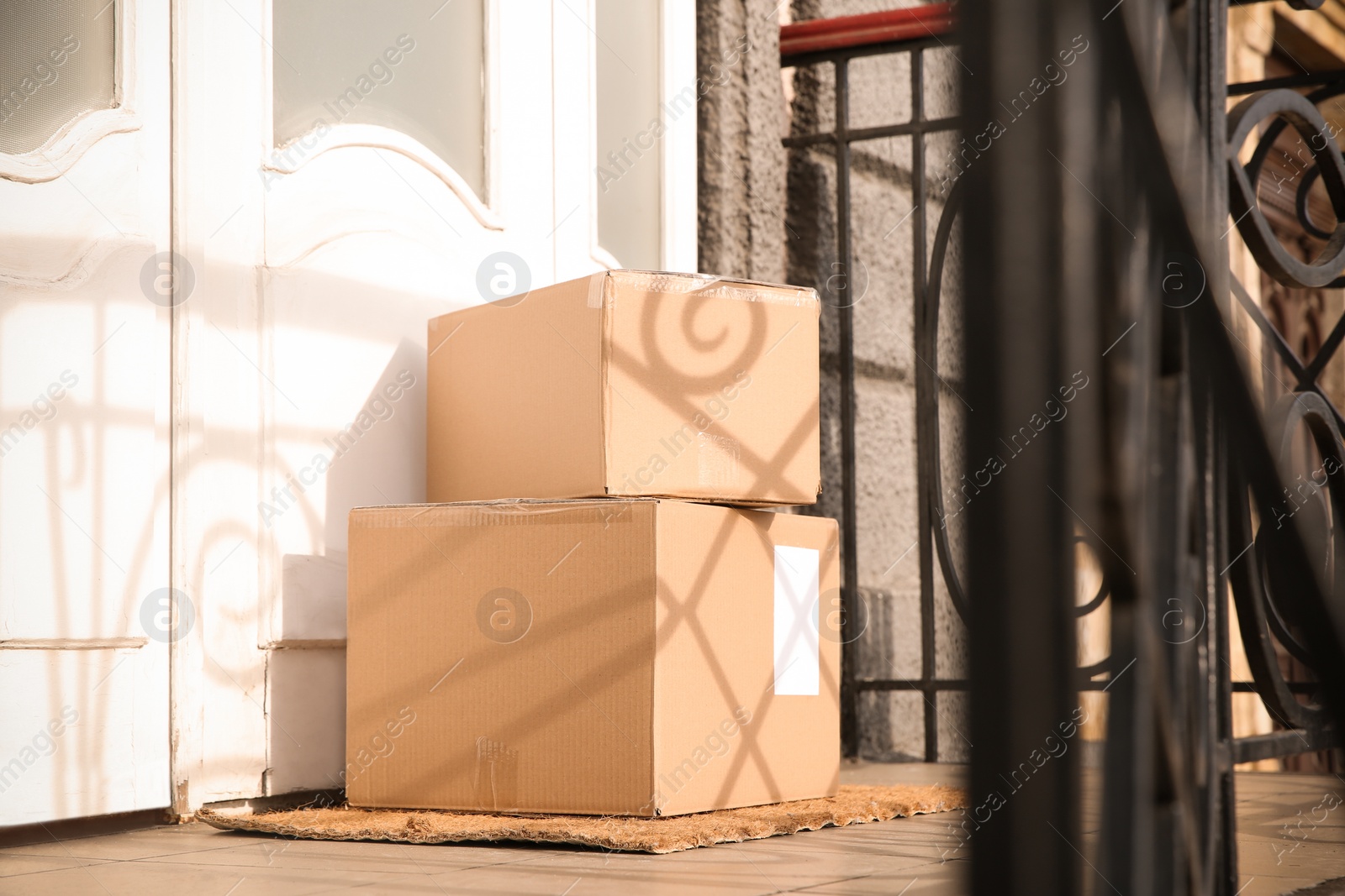 Photo of Delivered parcels on door mat near entrance