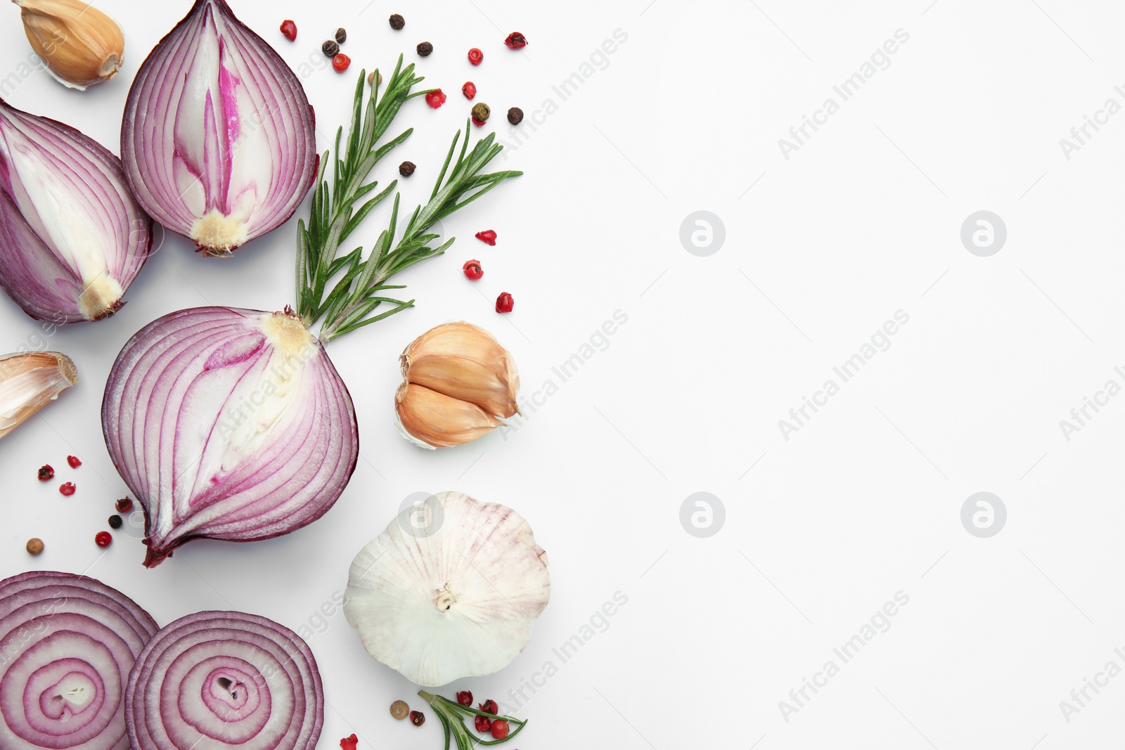 Photo of Fresh red onions, garlic, rosemary and spices on white background, flat lay. Space for text