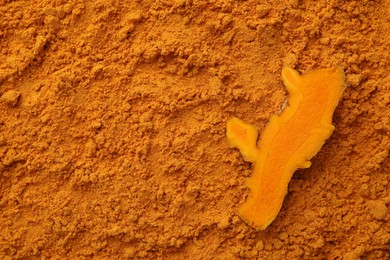 Cut root on aromatic turmeric powder, top view. Space for text