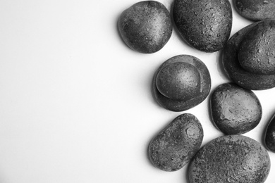 Photo of Wet zen stones on white background, top view with space for text