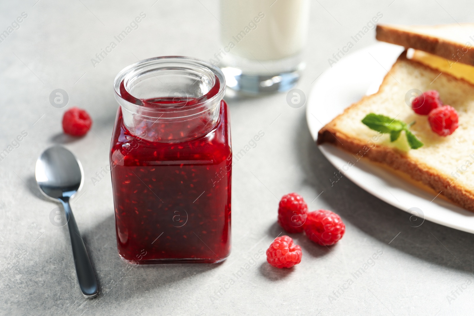 Image of Sweet raspberry jam and toasts for breakfast on table