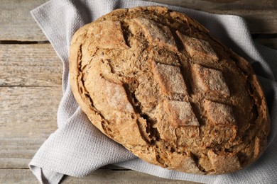 Photo of Freshly baked sourdough bread on wooden table, top view