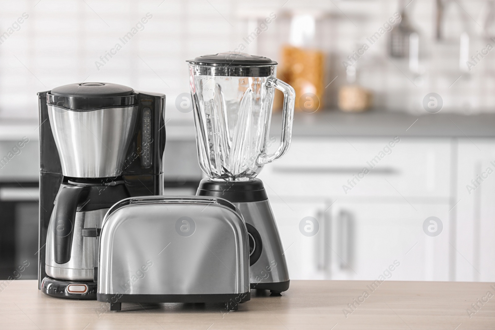 Photo of Kitchen appliances on table against blurred background