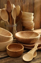 Photo of Many different wooden dishware and utensils on table