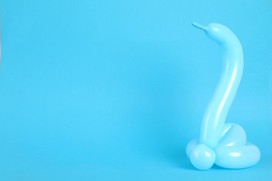 Photo of Snake figure made of modelling balloon on color background. Space for text