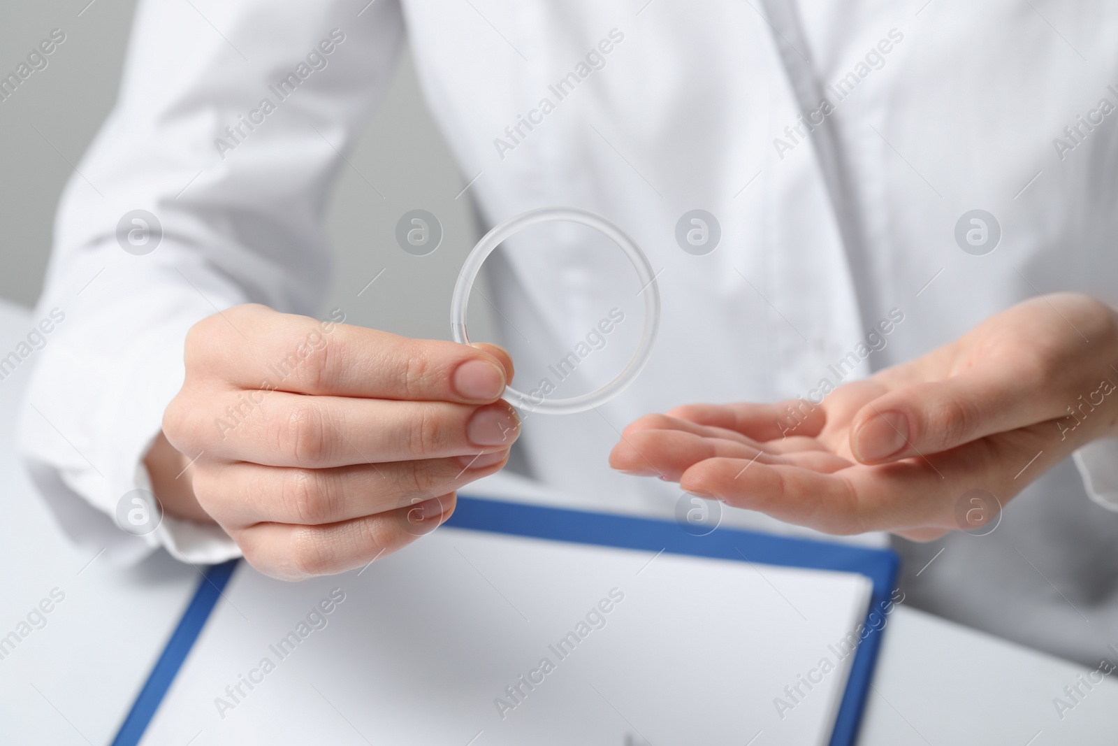 Photo of Doctor holding diaphragm vaginal contraceptive ring at table, closeup