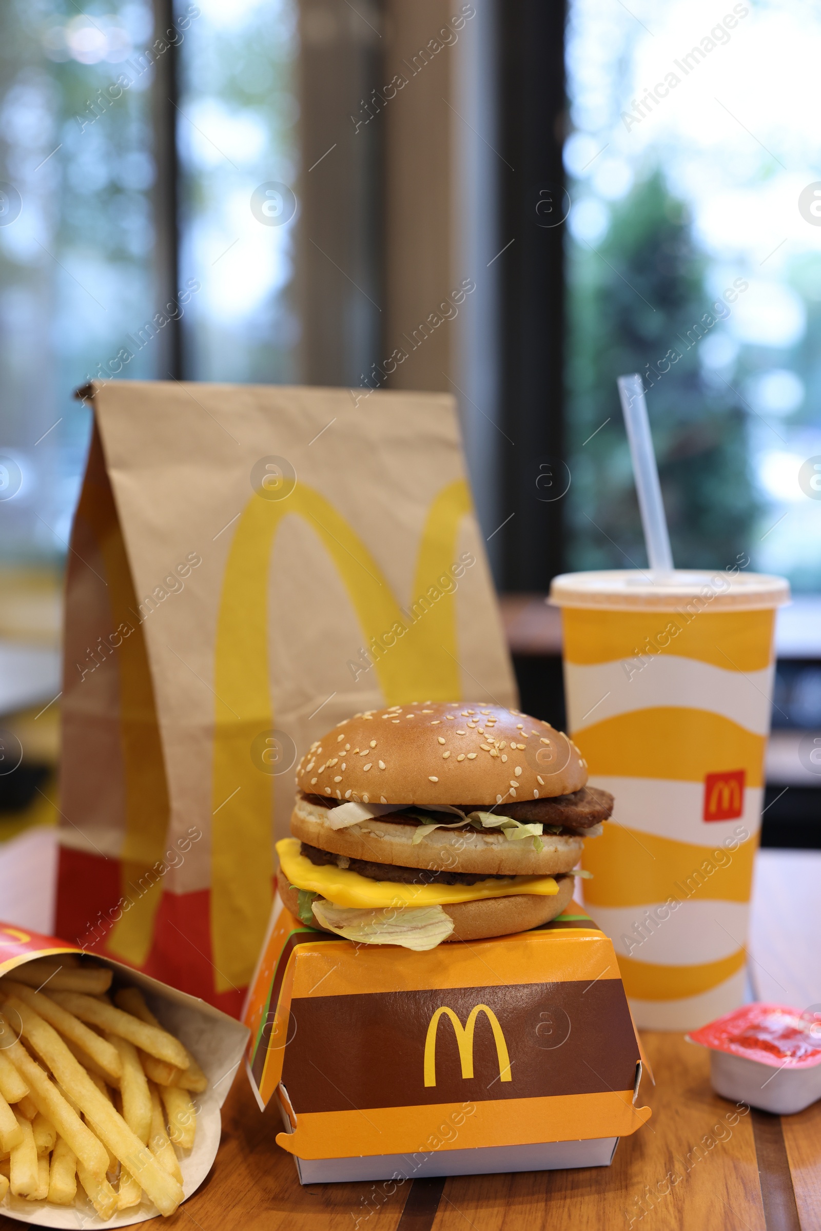 Photo of Lviv, Ukraine - October 9, 2023: McDonald's menu on wooden table in restaurant