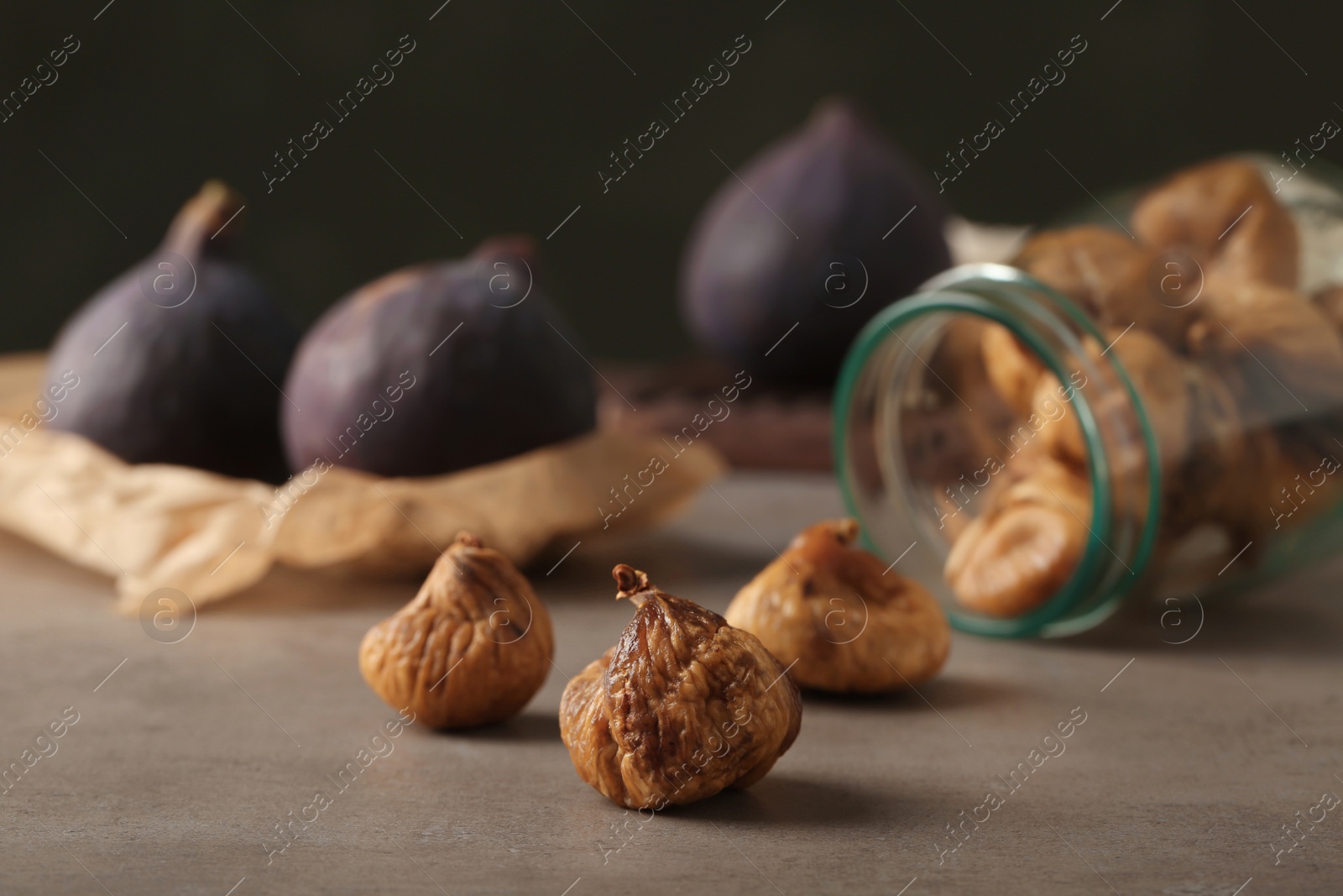 Photo of Delicious dried fig fruits on grey table. Organic snack
