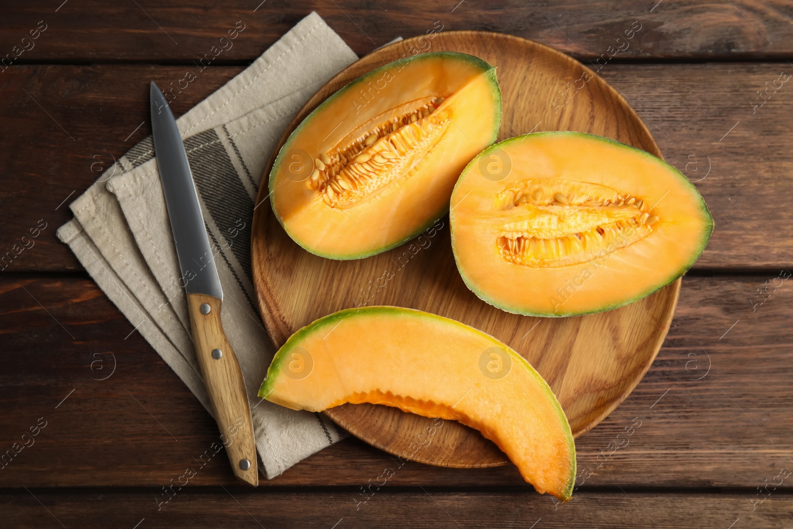 Photo of Tasty fresh cut melon on wooden table, flat lay