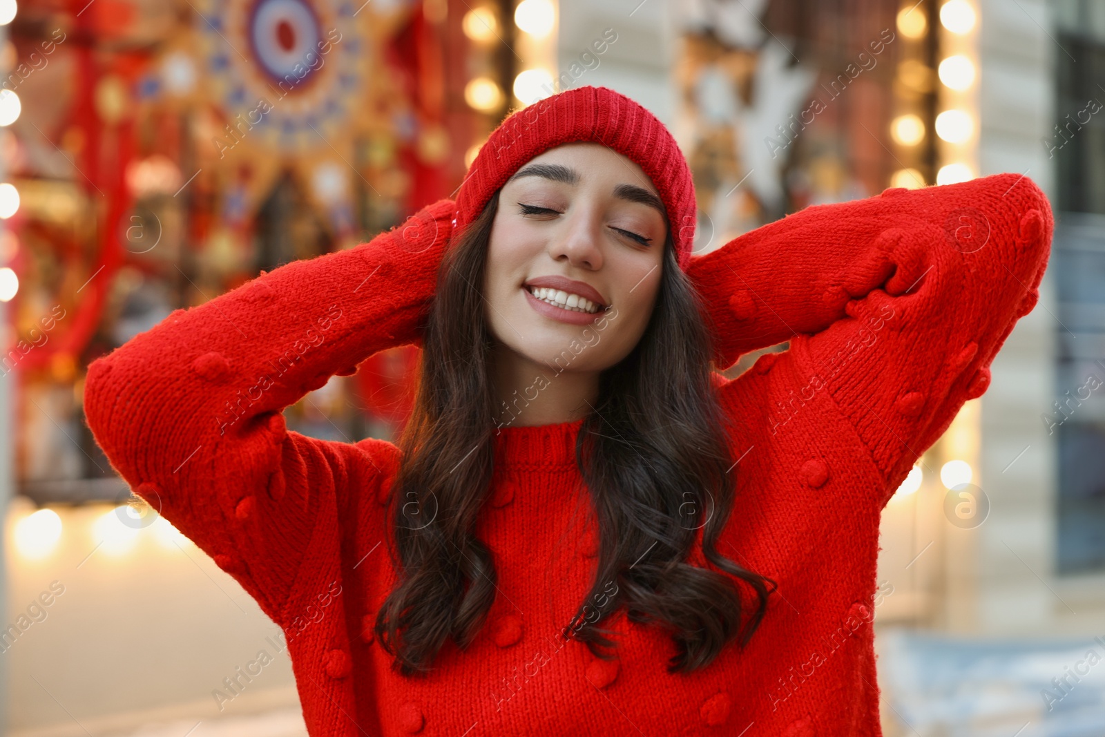 Photo of Portrait of smiling woman on blurred background. Winter time