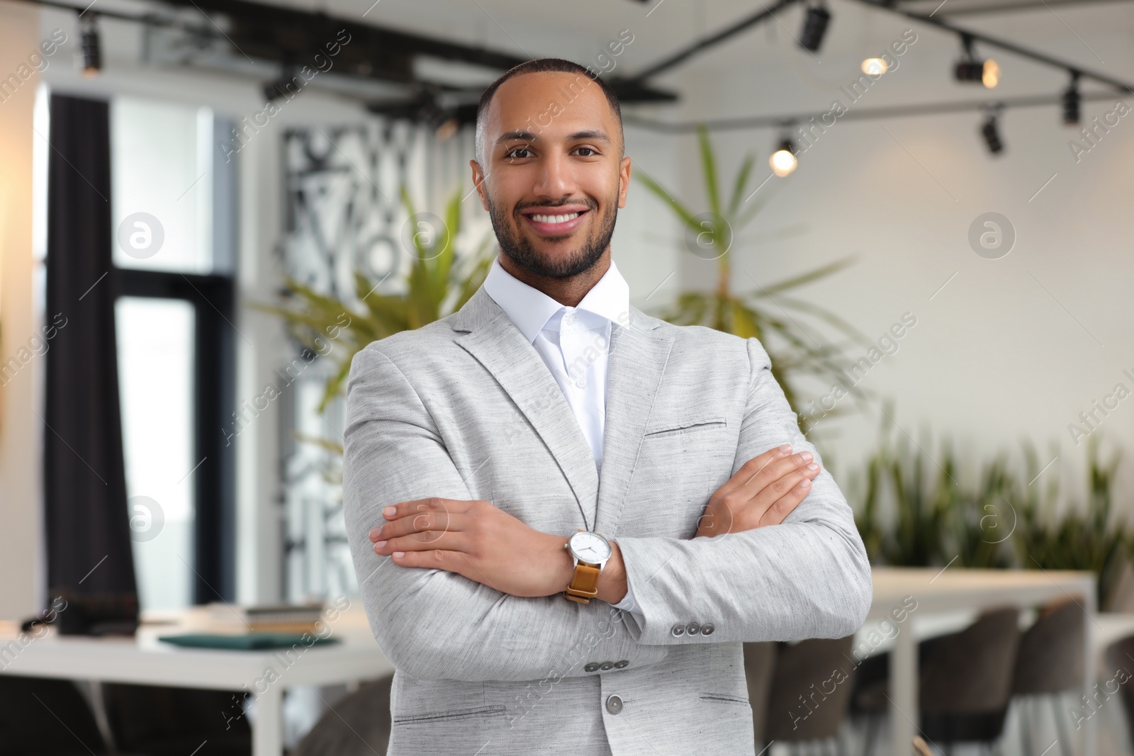 Photo of Happy man with crossed arms in office. Lawyer, businessman, accountant or manager