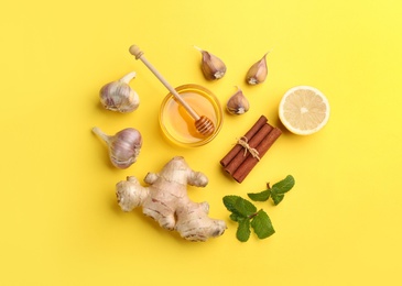 Photo of Flat lay composition with different natural antibiotics on yellow background