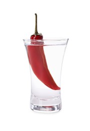 Photo of Red hot chili pepper and vodka in shot glass on white background