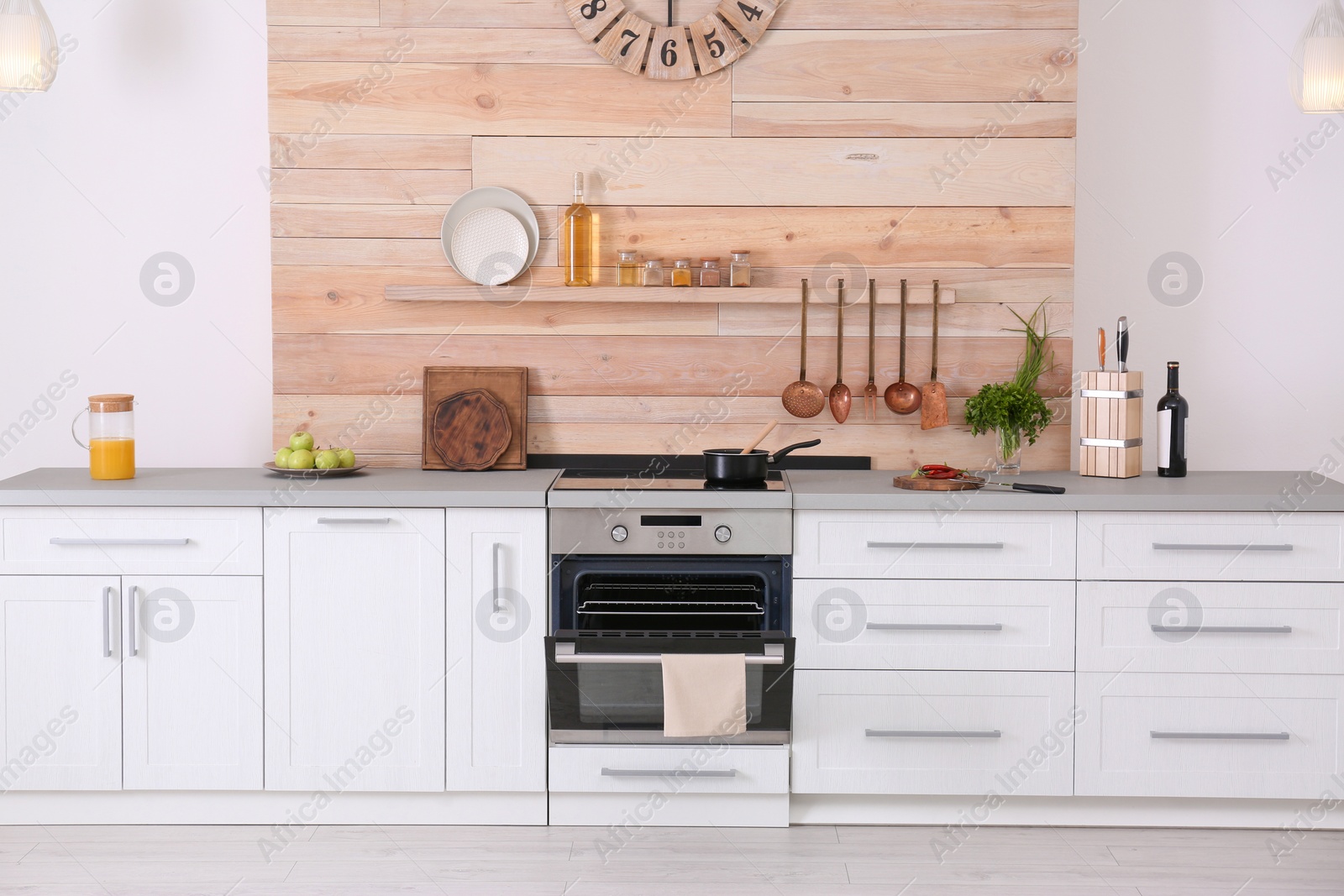 Photo of Light modern kitchen interior with new oven