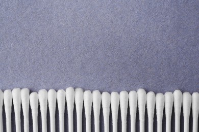 Photo of Many clean cotton buds on blue background, flat lay. Space for text