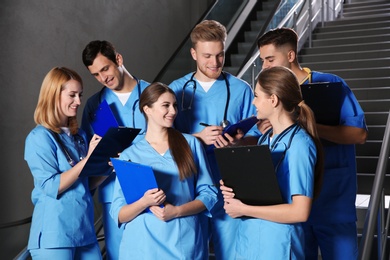 Young smiling medical students in university hall