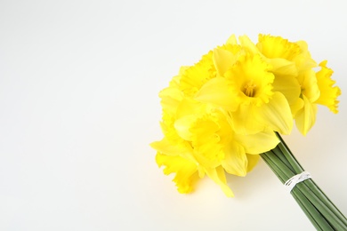 Photo of Bouquet of daffodils on white background, top view. Fresh spring flowers