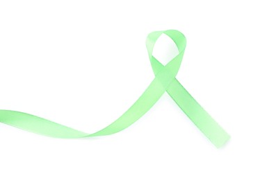 Photo of Light green awareness ribbon isolated on white, top view