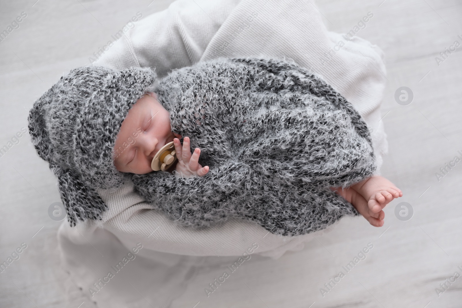 Photo of Cute newborn baby sleeping on plaid, top view