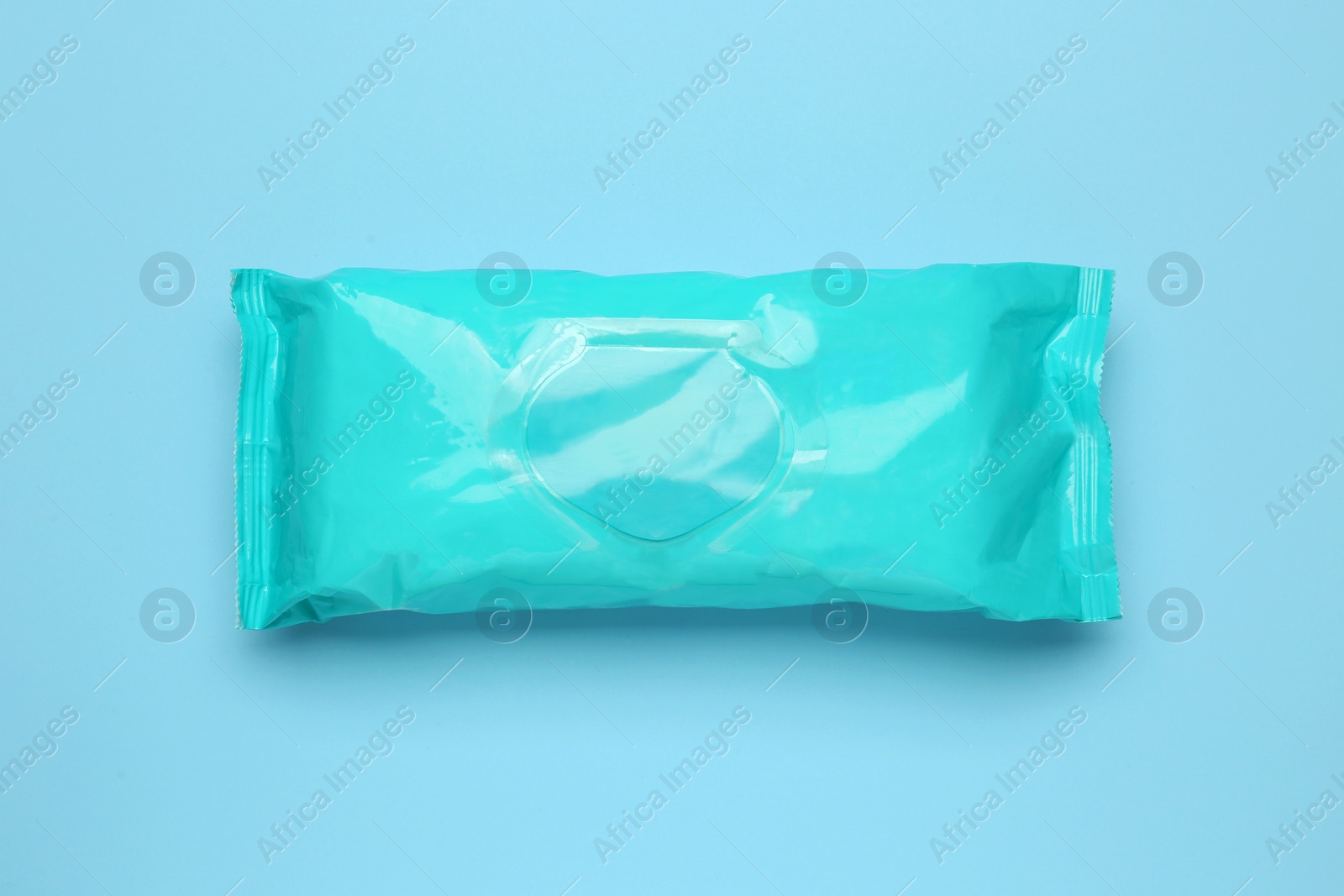 Image of Wet wipes flow pack on light blue background, top view