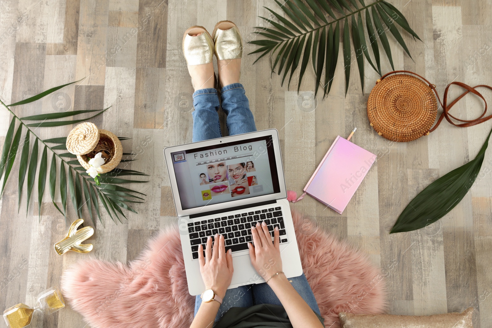 Photo of Woman and laptop with open fashion blogger site on floor, top view