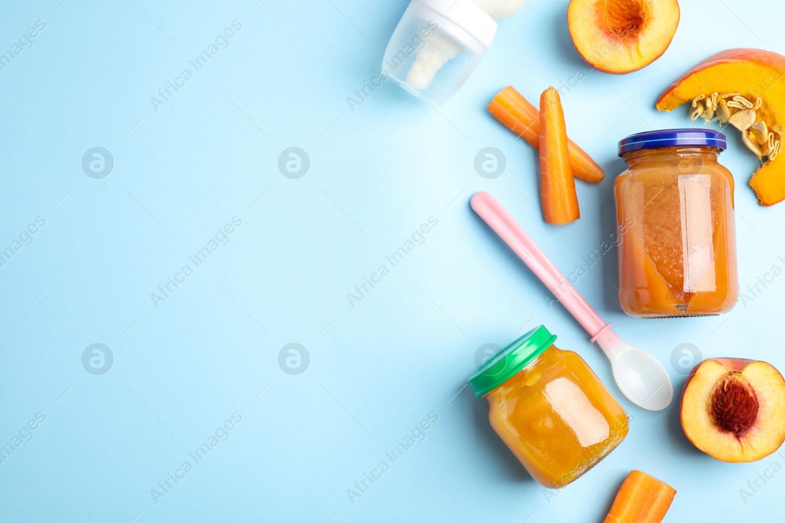 Photo of Flat lay composition with healthy baby food and ingredients on light blue background. Space for text