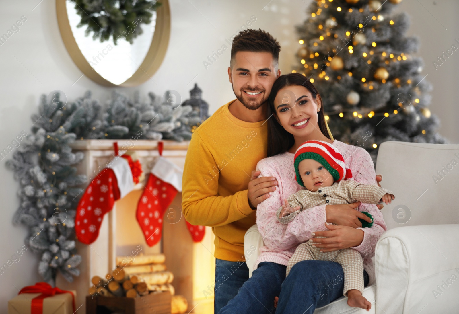 Photo of Happy family with cute baby at home. Christmas celebration