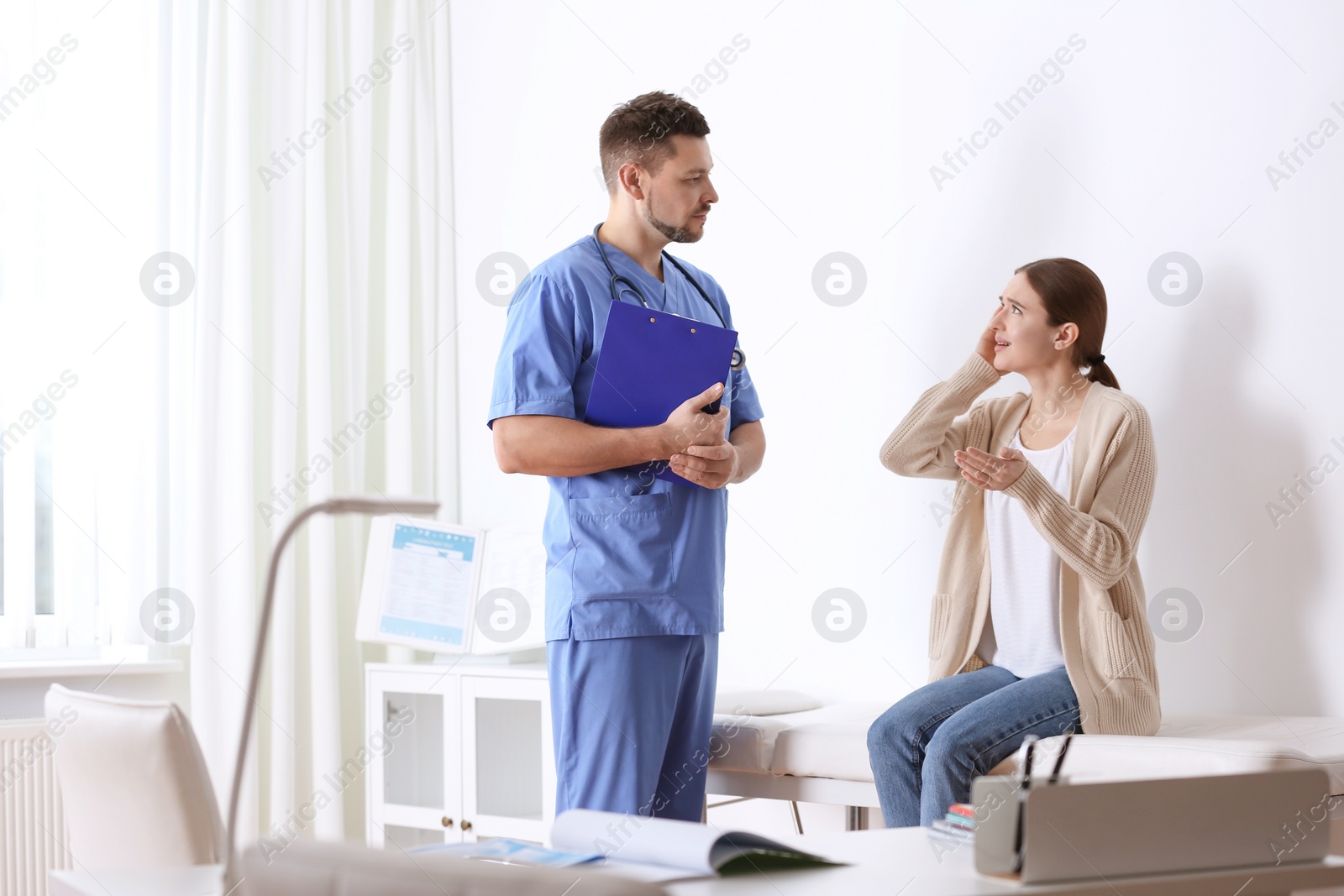 Photo of Doctor consulting patient in his office at hospital