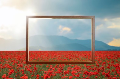 Image of Wooden frame and beautiful poppy meadow near mountains under cloudy sky