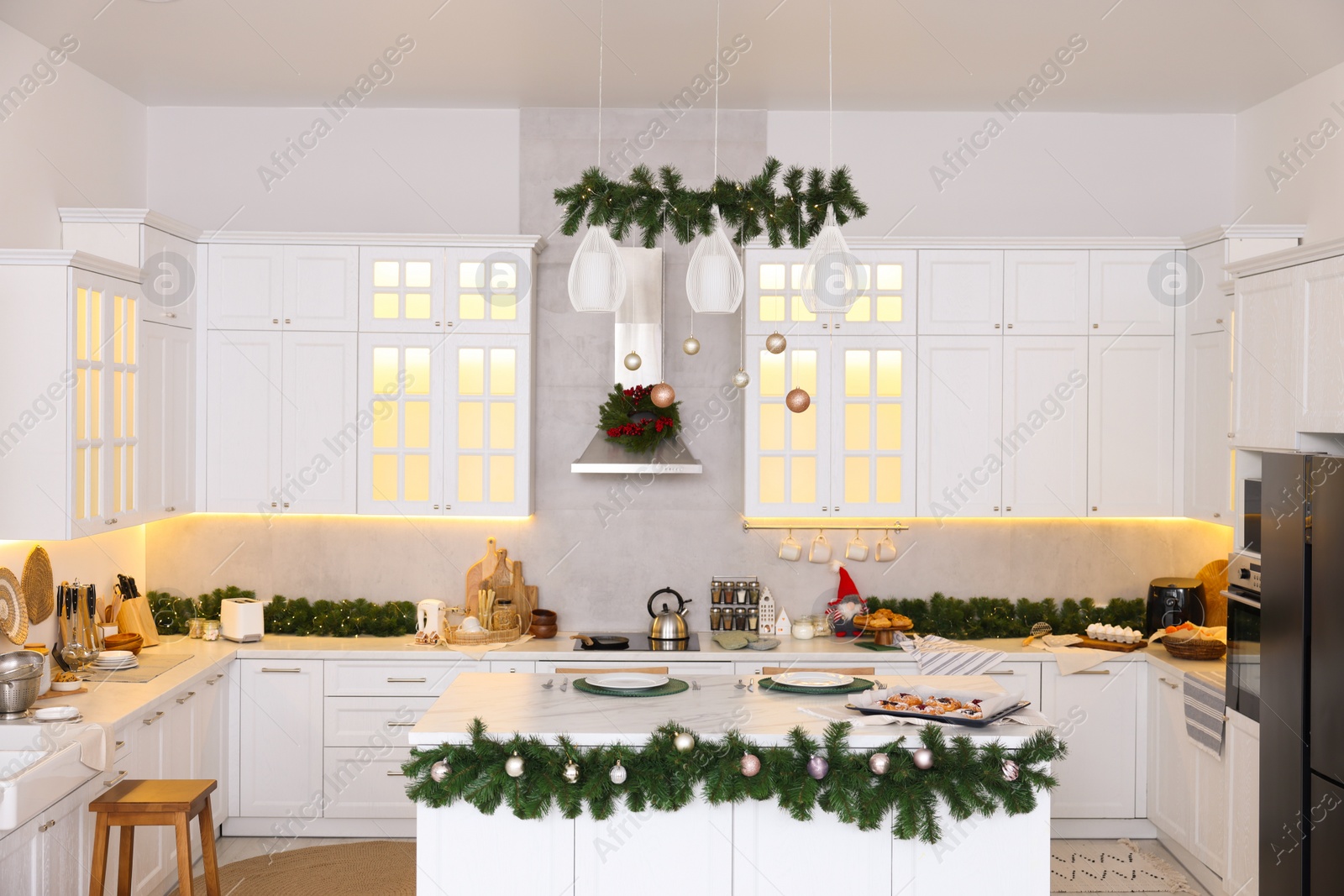 Photo of Cozy spacious kitchen decorated for Christmas. Interior design