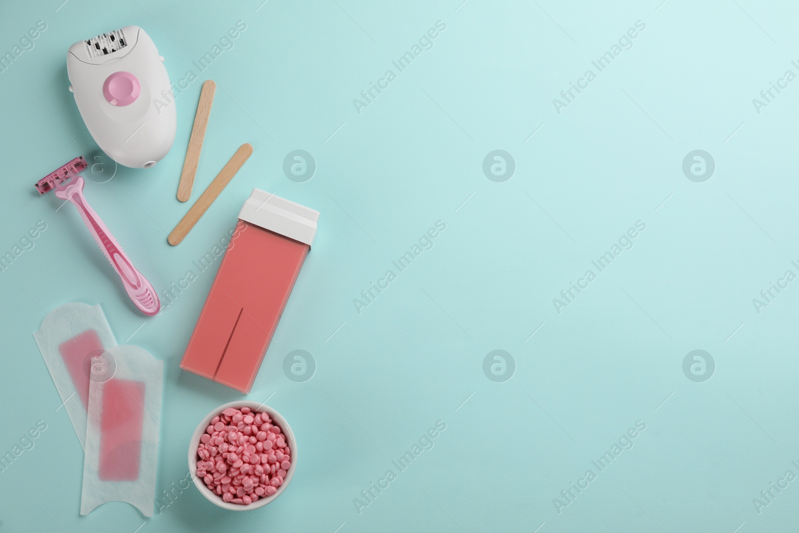 Photo of Set of epilation tools and products on turquoise background, flat lay. Space for text
