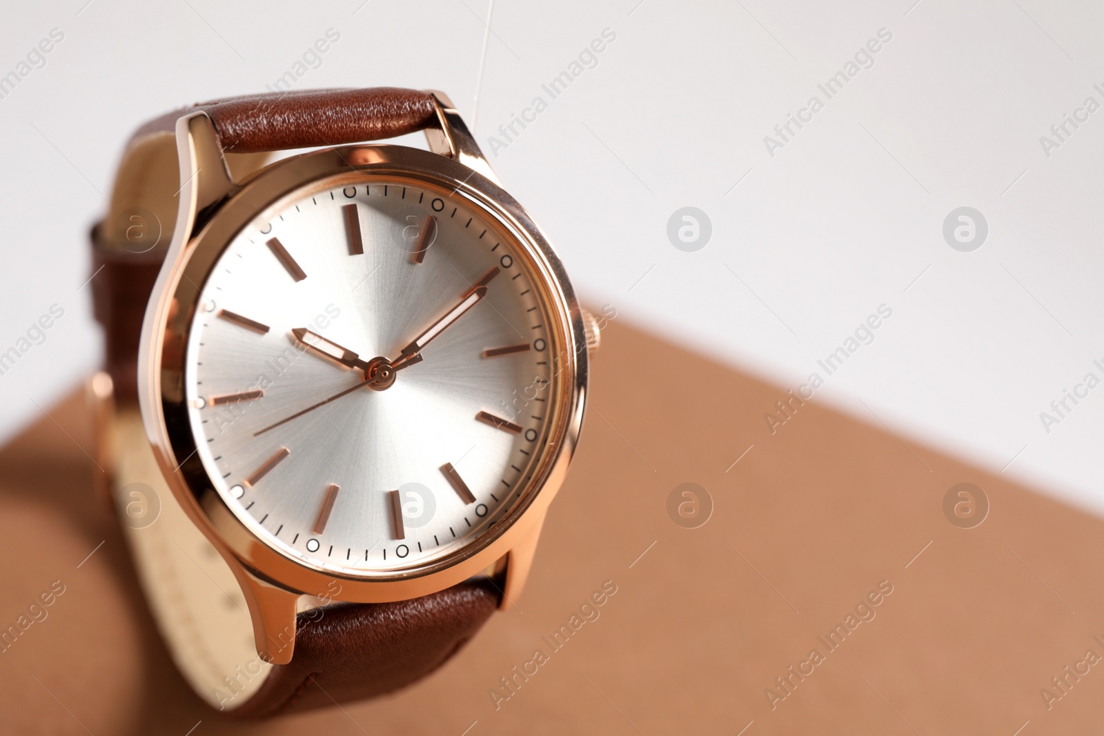 Photo of Luxury wrist watch on color background, closeup. Space for text