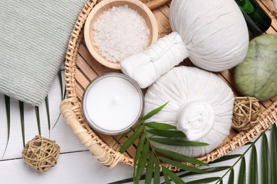 Photo of Flat lay composition with candle and different spa products on white wooden table